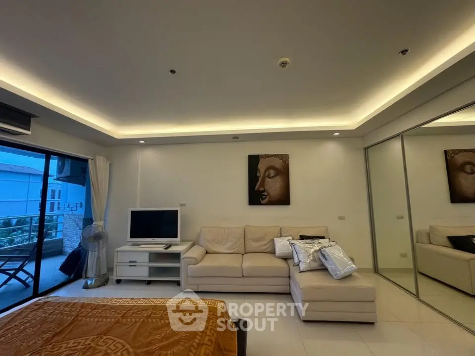 Modern living room with cozy beige sofa and balcony access