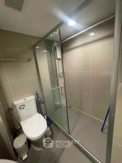 Modern bathroom with glass shower enclosure and sleek tile design