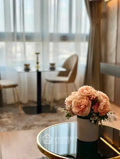Elegant living room with chic decor and large windows offering natural light.