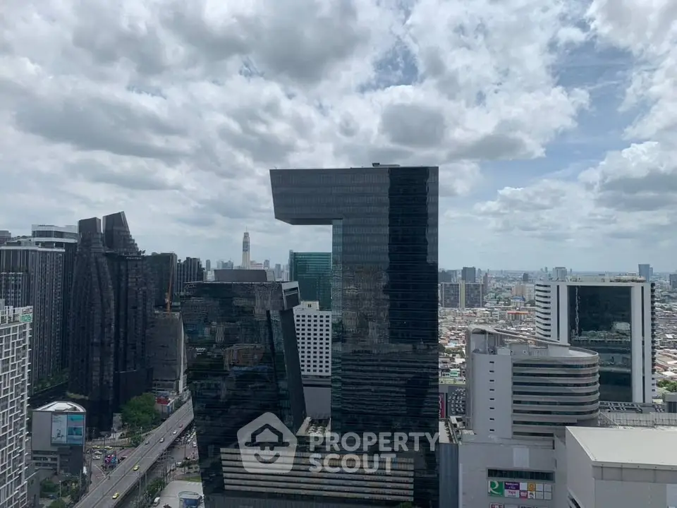 Stunning cityscape view with modern skyscrapers under a cloudy sky, showcasing urban architectural marvels.