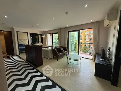 Spacious modern living room with stylish decor and balcony view in luxury apartment.