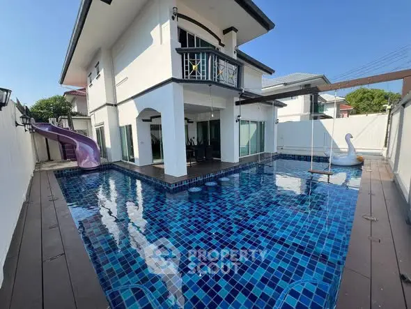Stunning modern home with private pool and playful slide, perfect for family entertainment.