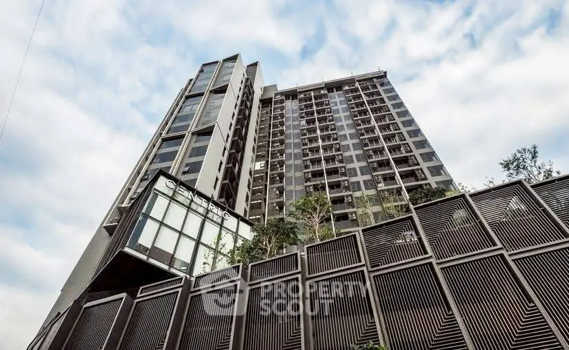 Modern high-rise building with sleek architectural design and glass facade.