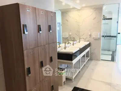 Modern bathroom with elegant sinks and wooden lockers