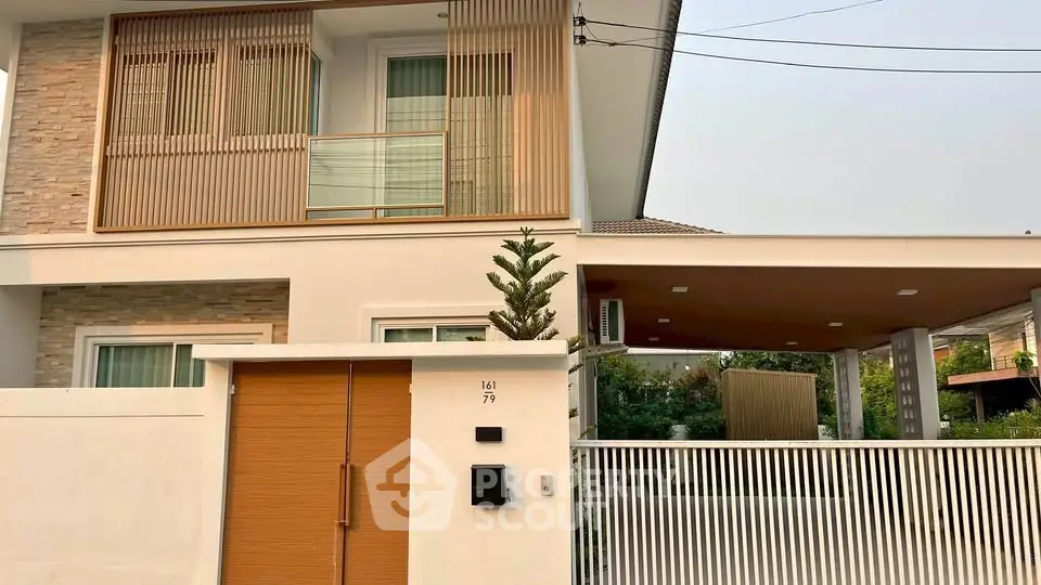 Modern two-story house with stylish facade and gated entrance