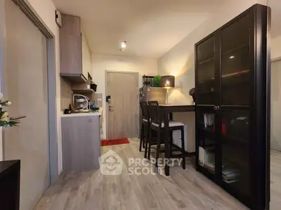 Modern kitchen with dining area and stylish cabinetry in cozy apartment