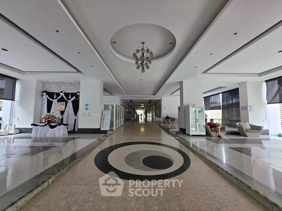 Luxurious building entrance with elegant chandelier and modern decor