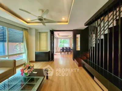 Spacious modern living room with wooden flooring and elegant dining area