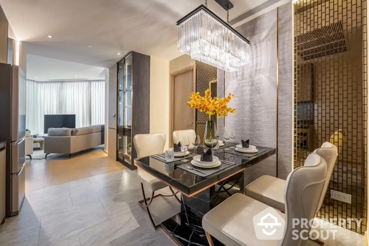 Luxurious modern dining area with elegant chandelier and open living room view