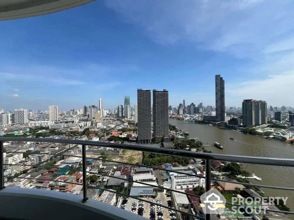 Stunning cityscape view from high-rise balcony overlooking river and skyline.