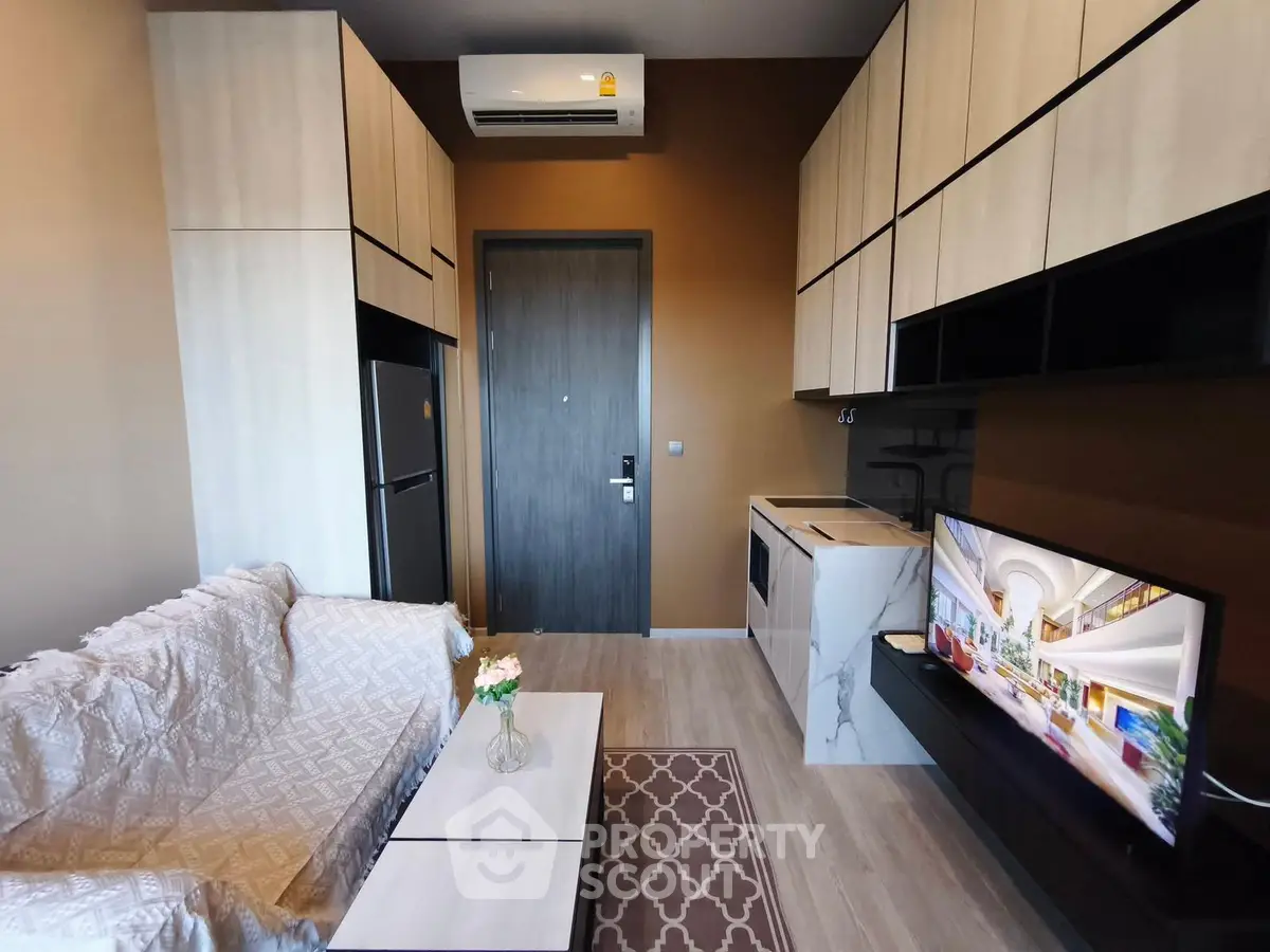 Modern living room with sleek cabinetry and air conditioning in a stylish apartment.