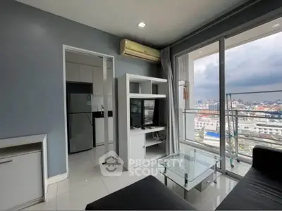 Modern living room with city view, featuring sleek furniture and large windows for natural light.
