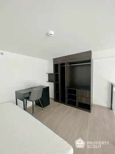 Modern minimalist bedroom with built-in closet and study desk