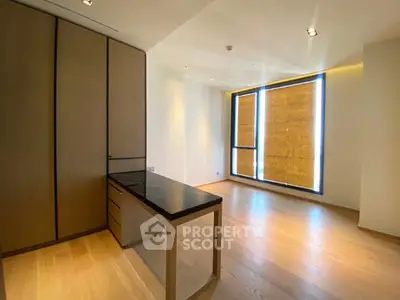 Spacious modern study room with wooden flooring and large window