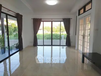 Spacious living room with large windows and garden view