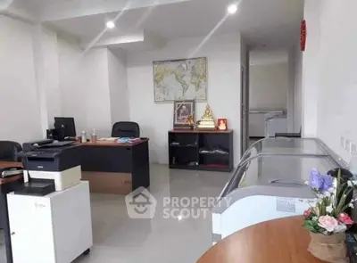 Spacious office interior with modern furniture and decor, ideal for professional work environment.