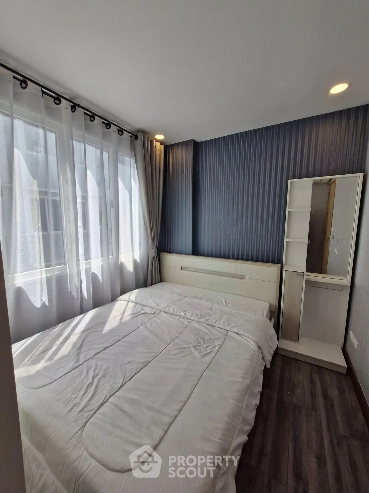 Cozy bedroom with natural light and modern decor
