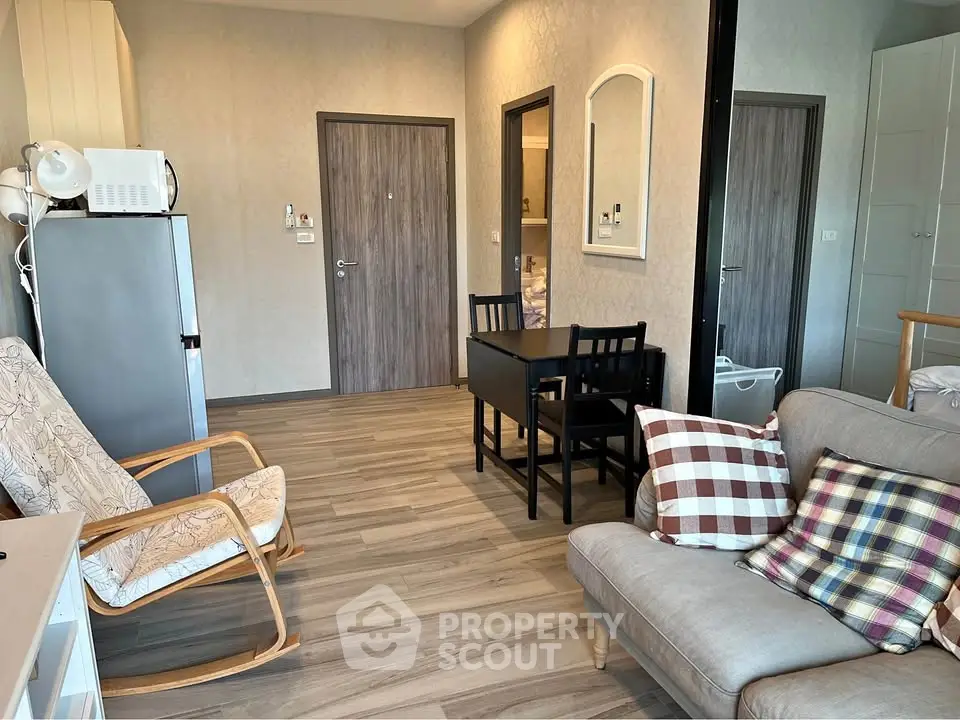 Cozy living room with modern furniture and dining area in open layout apartment.