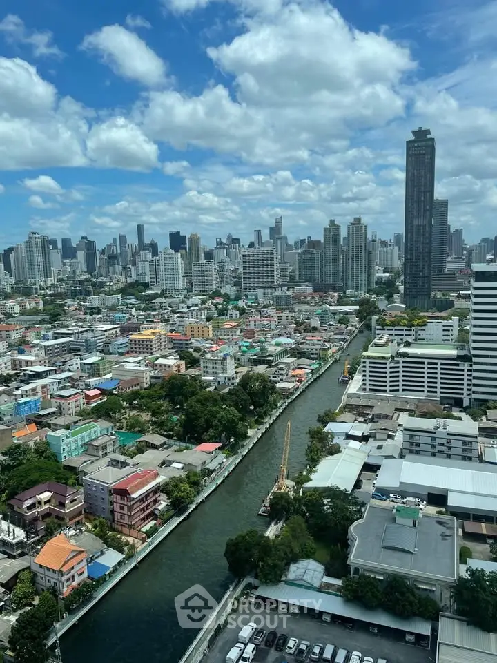 Stunning cityscape view from high-rise building overlooking river and skyline, perfect for urban living.