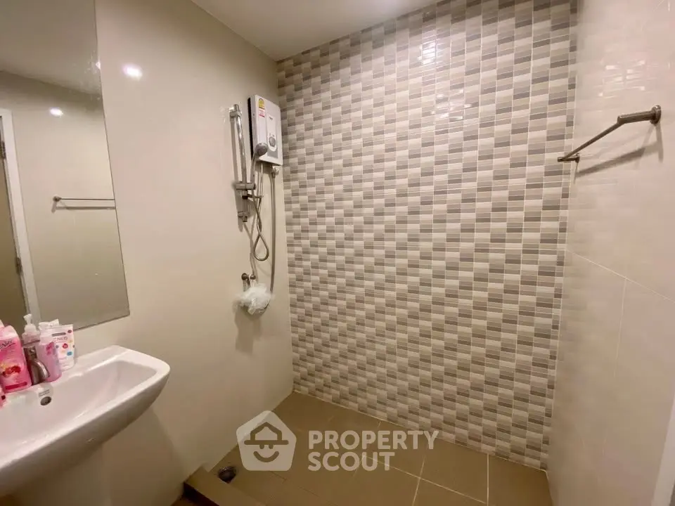 Modern bathroom with tiled wall and shower in sleek design