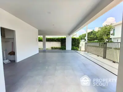 Spacious covered parking area with modern design and garden view