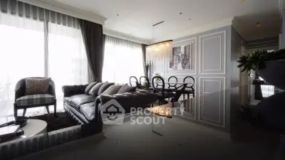 Luxurious living room with elegant decor and chandelier in modern apartment.