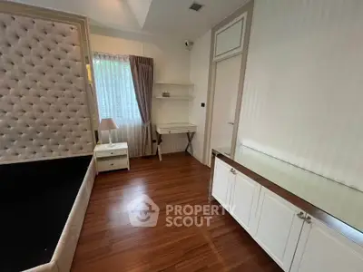 Elegant bedroom with wooden flooring and stylish furniture