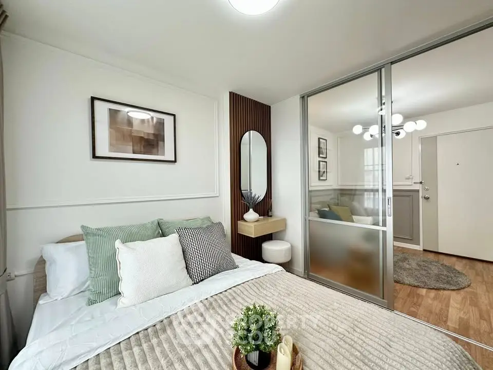 Modern bedroom with stylish decor and sliding glass doors leading to a cozy living area.