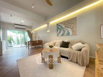 Spacious living room with modern decor and dining area, featuring natural light and stylish furnishings.