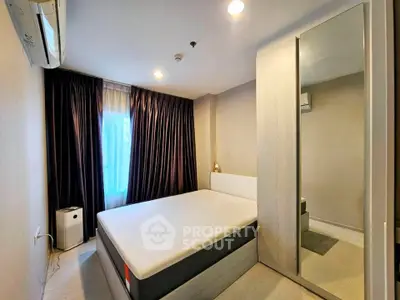 Modern bedroom with large bed, mirrored wardrobe, and air conditioning in a cozy apartment.