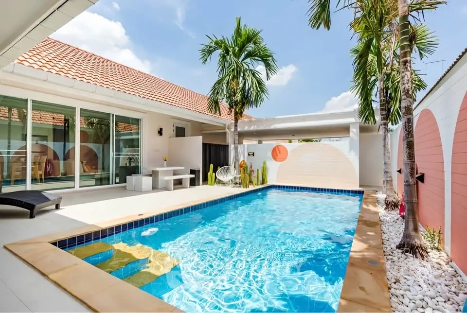 Stunning villa with private pool and modern outdoor seating area, perfect for relaxation and entertainment.