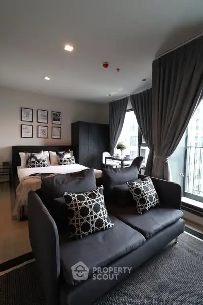 Modern studio apartment with stylish decor and large windows