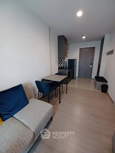 Modern apartment interior with cozy living area and compact kitchen