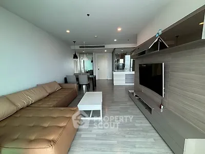 Spacious modern living room with sleek furniture and large TV unit, perfect for relaxation and entertainment.