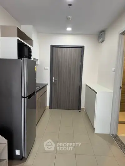 Modern kitchen with sleek appliances and minimalist design in a contemporary apartment.