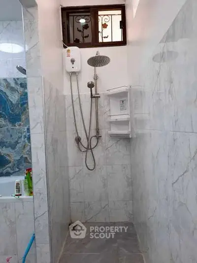Modern bathroom with marble tiles and shower area