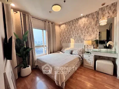 Elegant bedroom with city view, stylish decor, and ample natural light in modern apartment.