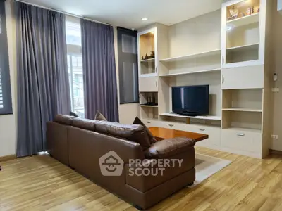 Spacious living room with leather sofa and built-in entertainment center