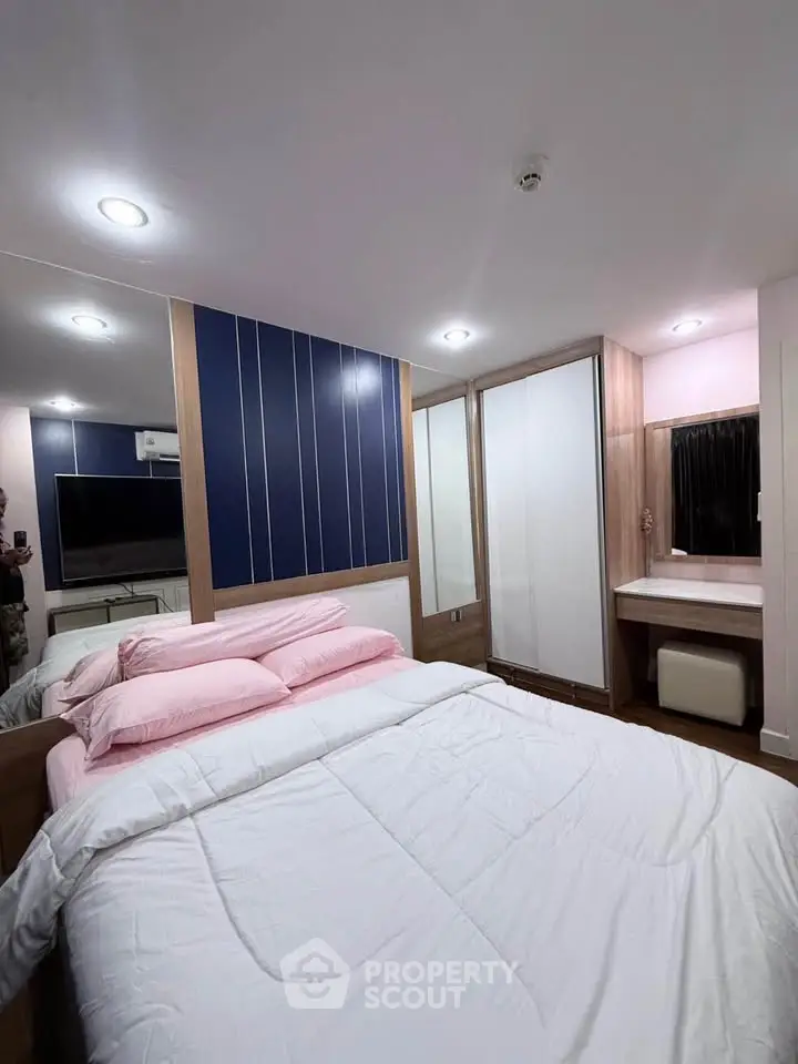 Modern bedroom with stylish decor, featuring a large bed, mirrored wardrobe, and ambient lighting.