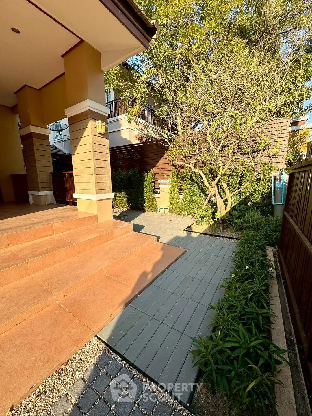 Charming garden entrance with lush greenery and elegant stone pathway