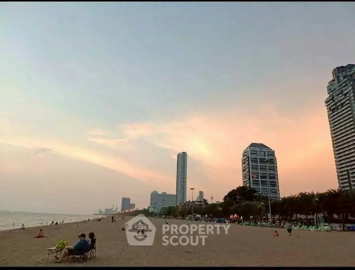 Stunning beachfront view with modern high-rise buildings at sunset