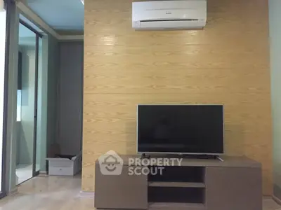 Modern living room with sleek TV setup and air conditioning unit, featuring stylish wood paneling.