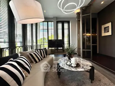 Luxurious living room with modern decor and large windows offering natural light.