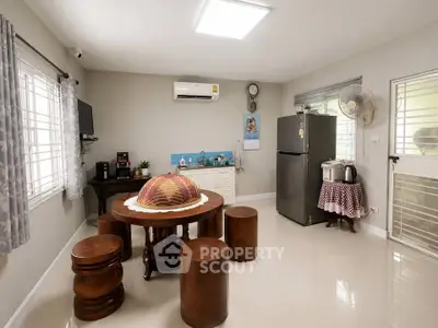Spacious kitchen with modern appliances and cozy dining area, perfect for family gatherings.