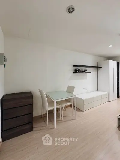 Modern minimalist living room with sleek furniture and wooden flooring