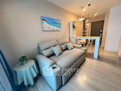 Modern living room with stylish sofa and open kitchen layout, perfect for cozy urban living.