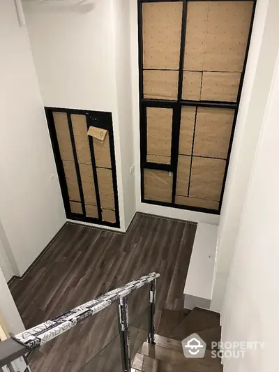 Modern staircase with large windows and wooden flooring in a contemporary home