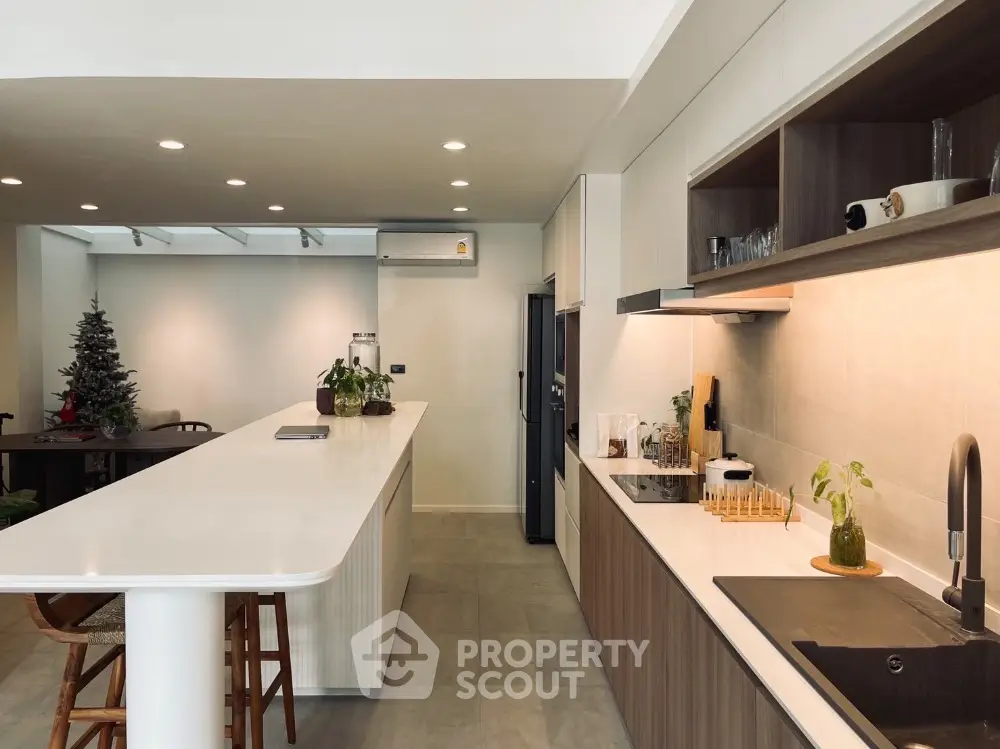 Modern kitchen with sleek design, featuring open layout and stylish countertops, perfect for culinary enthusiasts.