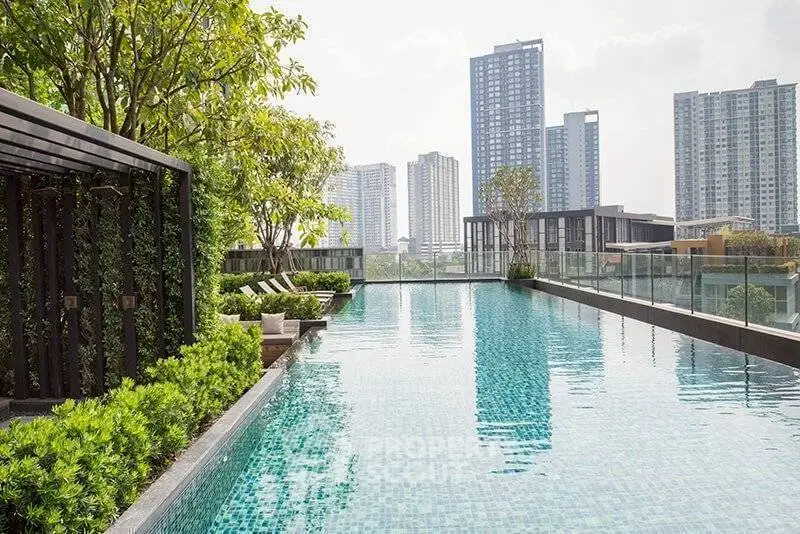 Luxurious rooftop pool with stunning city skyline views in modern high-rise building.