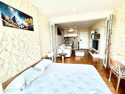 Spacious bedroom with open layout and modern decor in a stylish apartment.